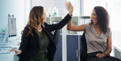 Women at the office giving a high five