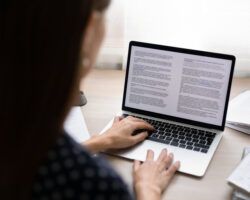 woman working on article on laptop