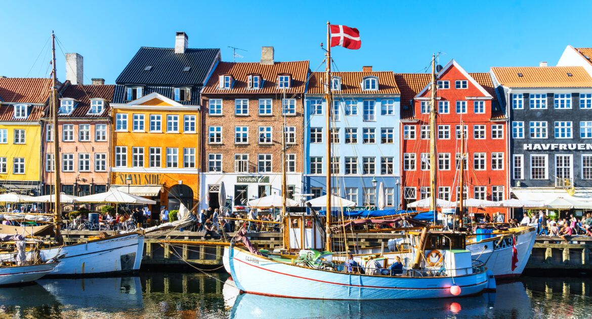 Copenhagen Nyhavn panorama city crowds enjoying sunshine restaurants bars Denmark
