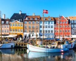 Copenhagen Nyhavn panorama city crowds enjoying sunshine restaurants bars Denmark