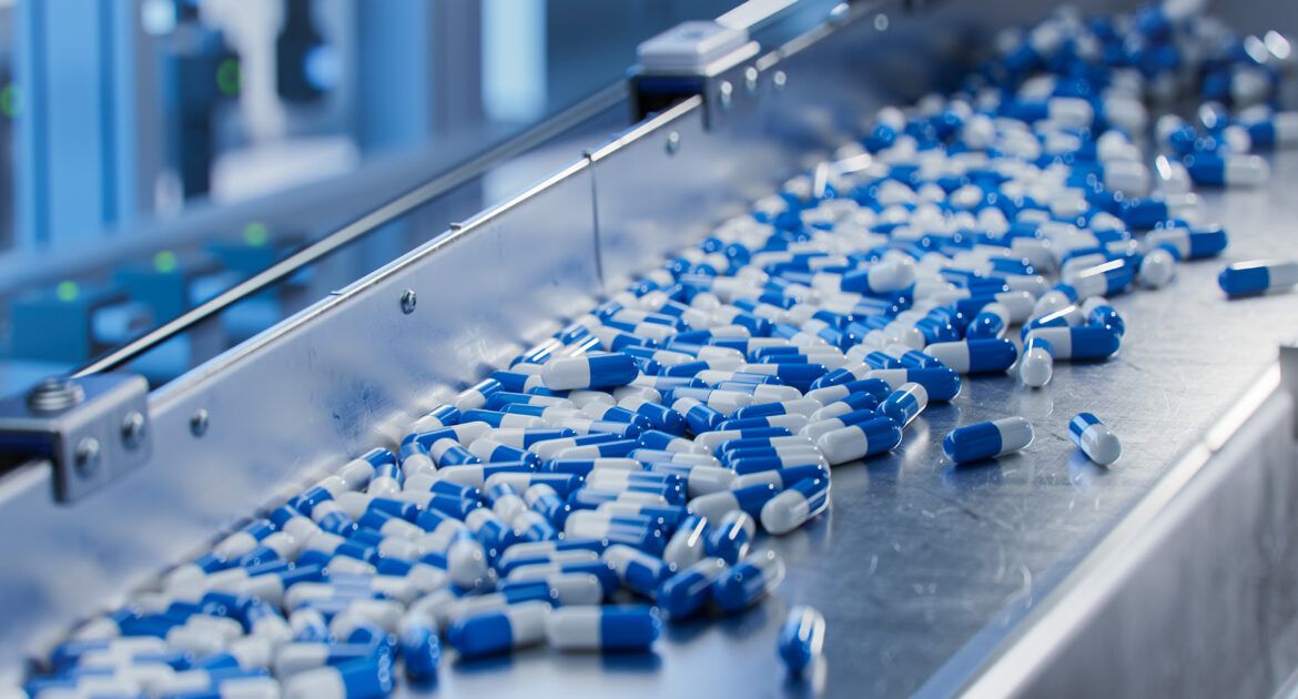 Blue Capsules on Conveyor at Modern Pharmaceutical Factory. Tablet and Capsule Manufacturing Process. Close up Shot of Medical Drug Production Line.