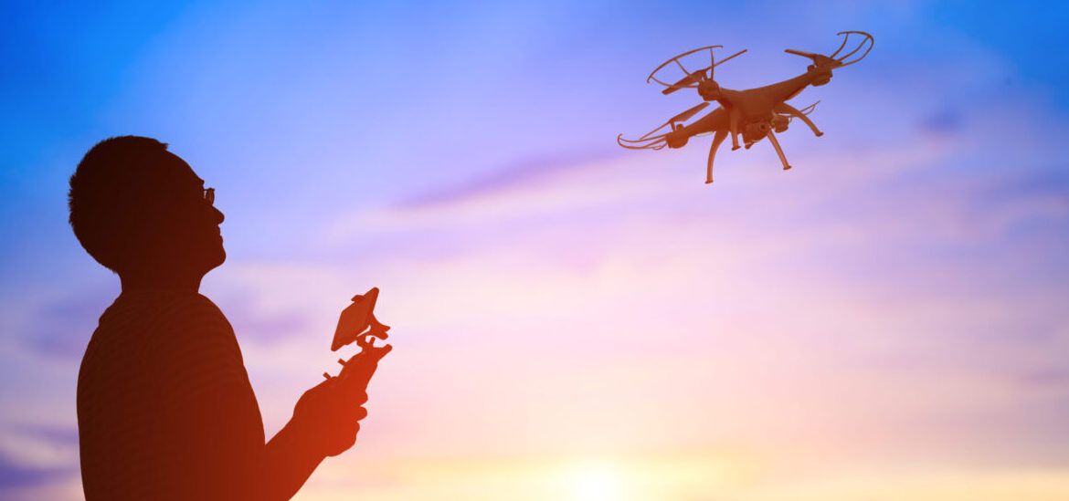 silhouette of man take drone