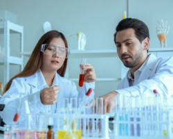 male and female conducting experiments in lab